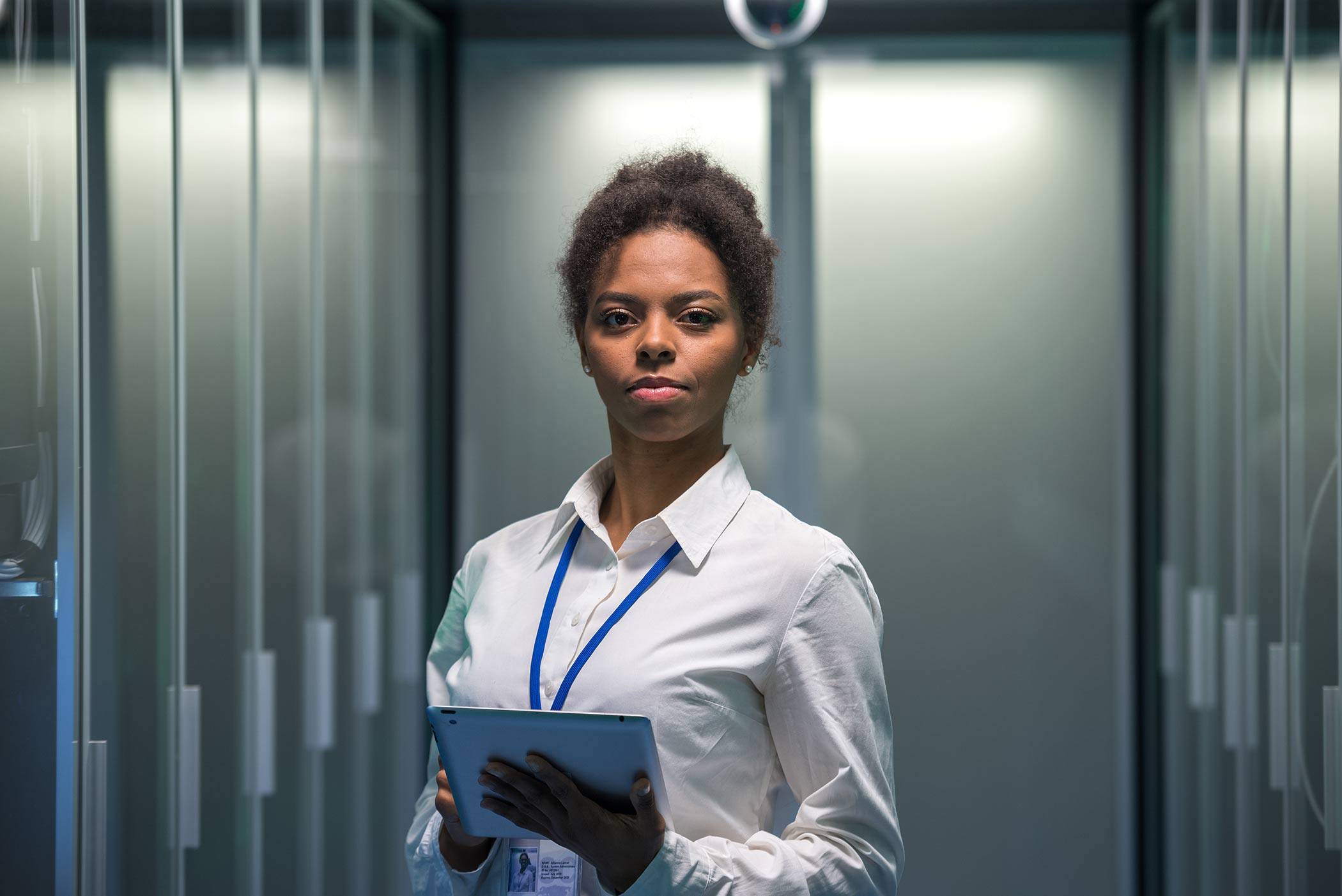 Black female IT worker in server room.